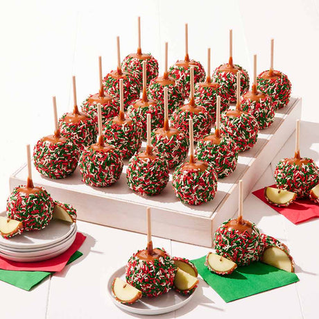 Decorative caramel apples with sprinkles on a white surface